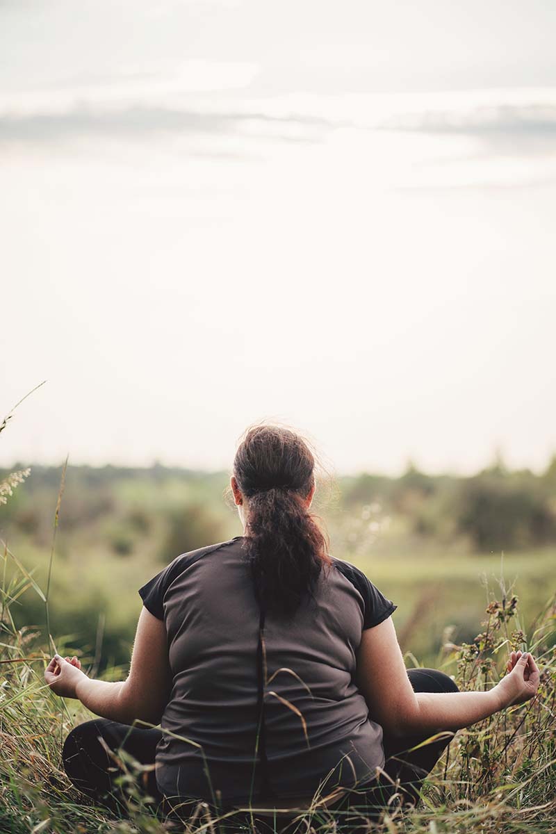 Woman Meditating in a Field