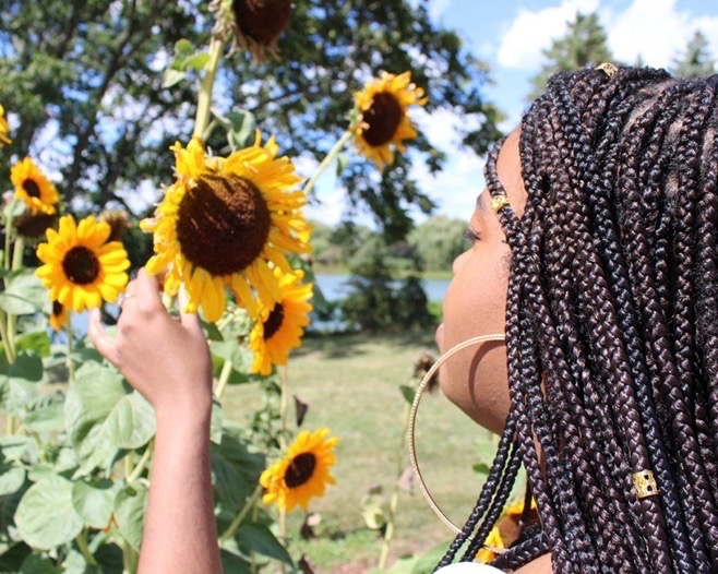 Woman smelling a sunflower